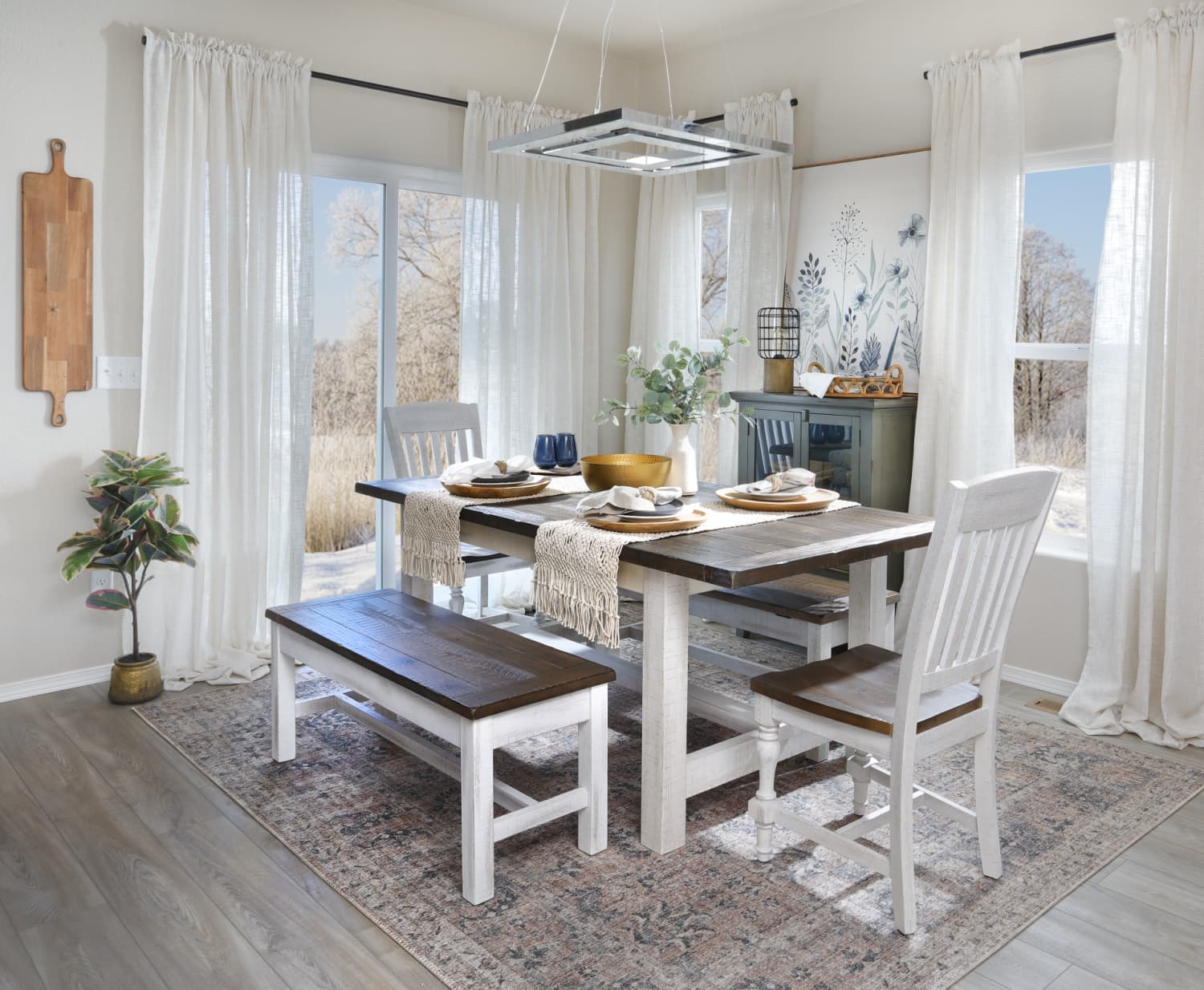 A dining set made from wood with white bases and brown tops, featuring a dining table, dining chairs, and a bench in a dining room