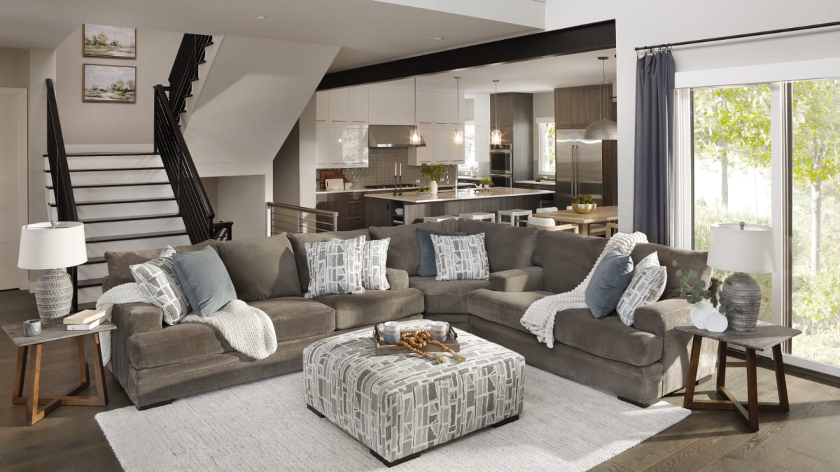 A comfy brown sectional and ottoman in living room