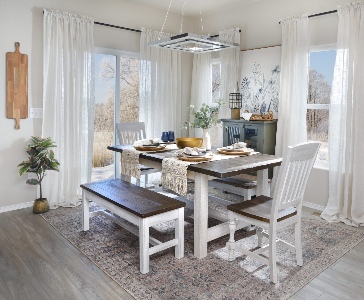 A dining set made from wood with white bases and brown tops, featuring a dining table, dining chairs, and a bench in a dining room
