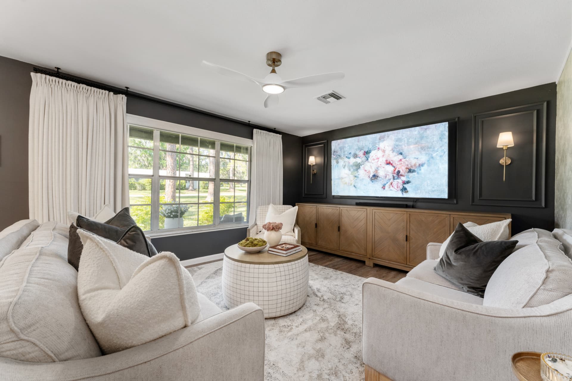 Round coffee table styled in center of Kelli Batemen's Airbnb living room