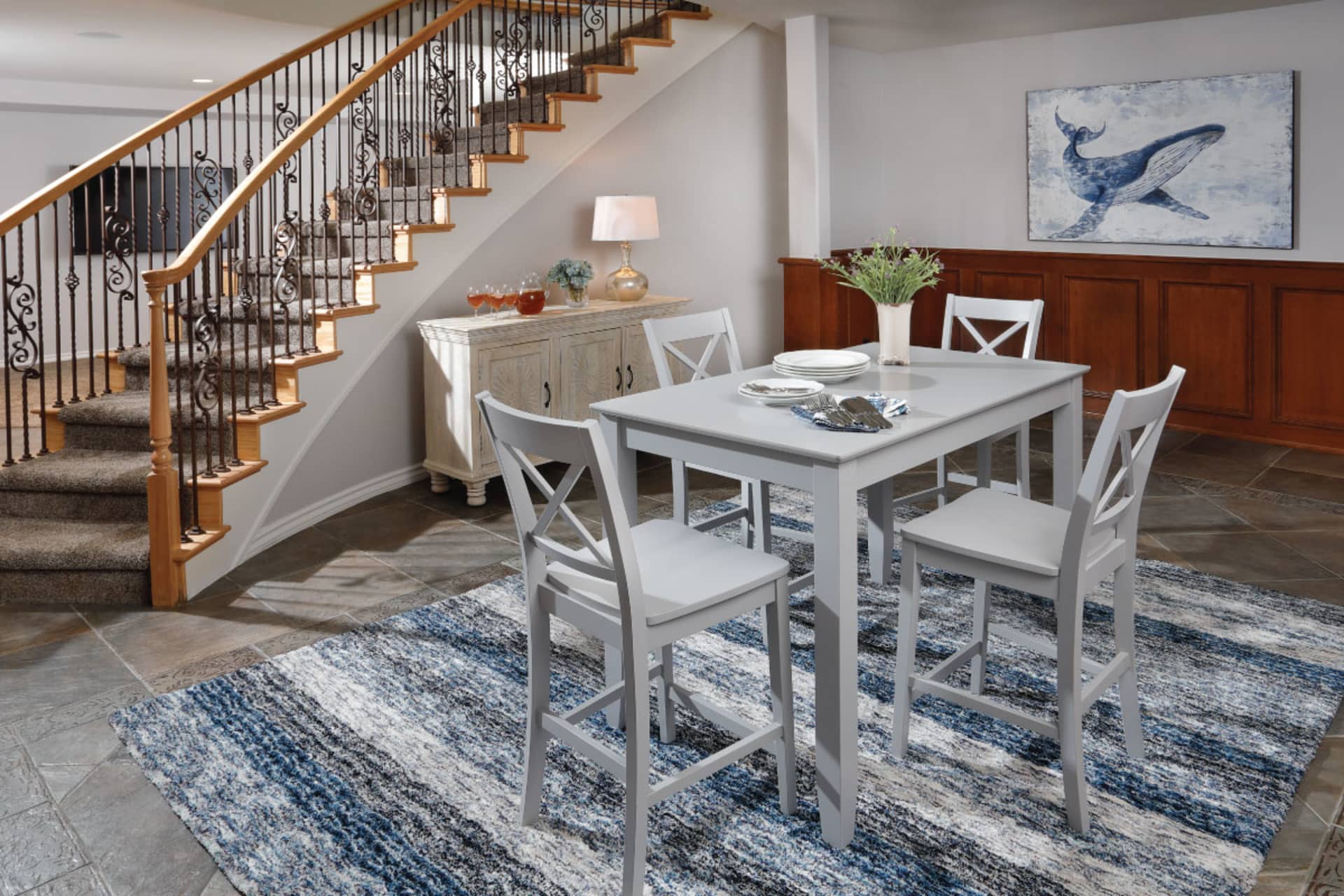 A gray counter height table set in a room