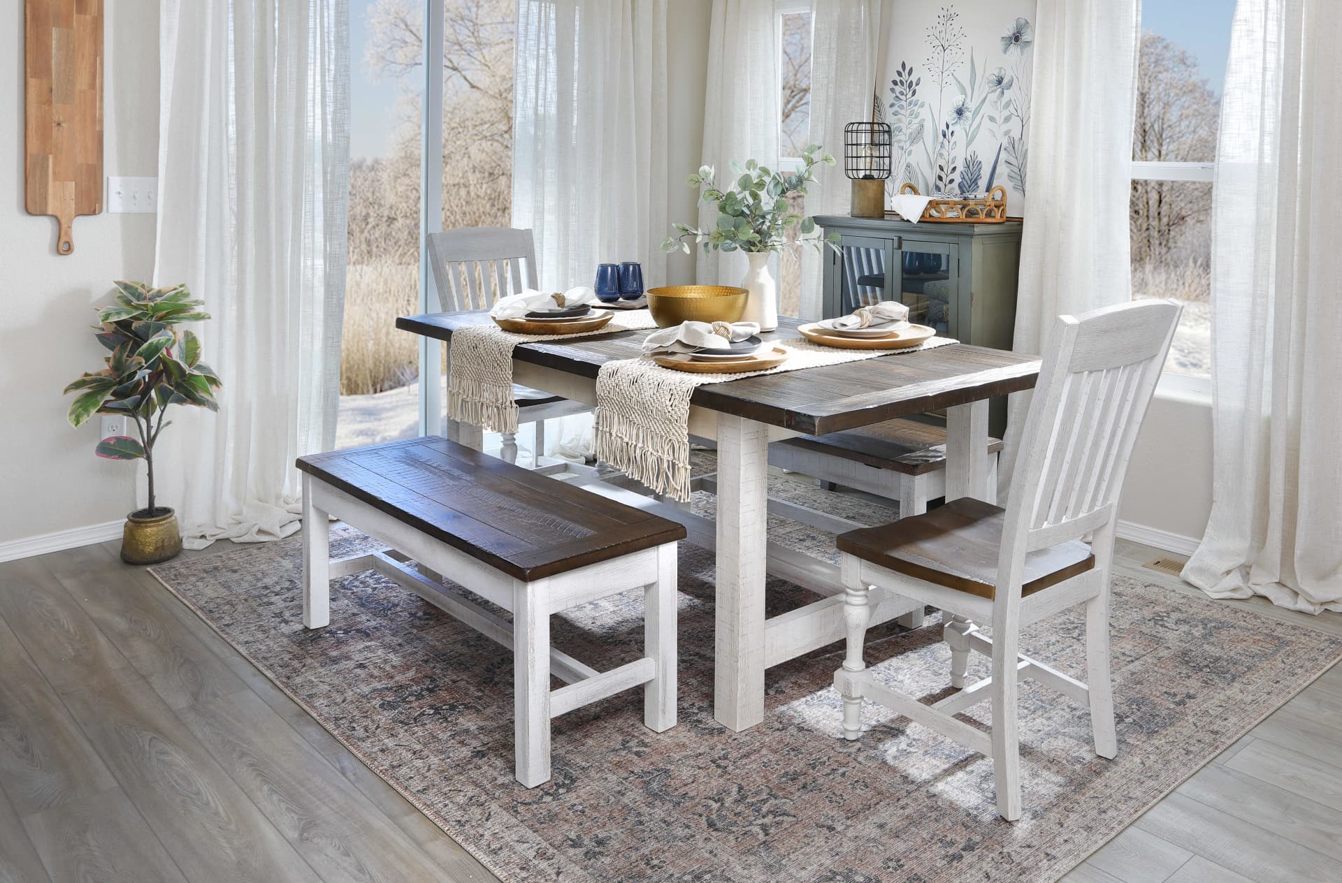A dining set made from wood with white bases and brown tops, featuring a dining table, dining chairs, and a bench in a dining room