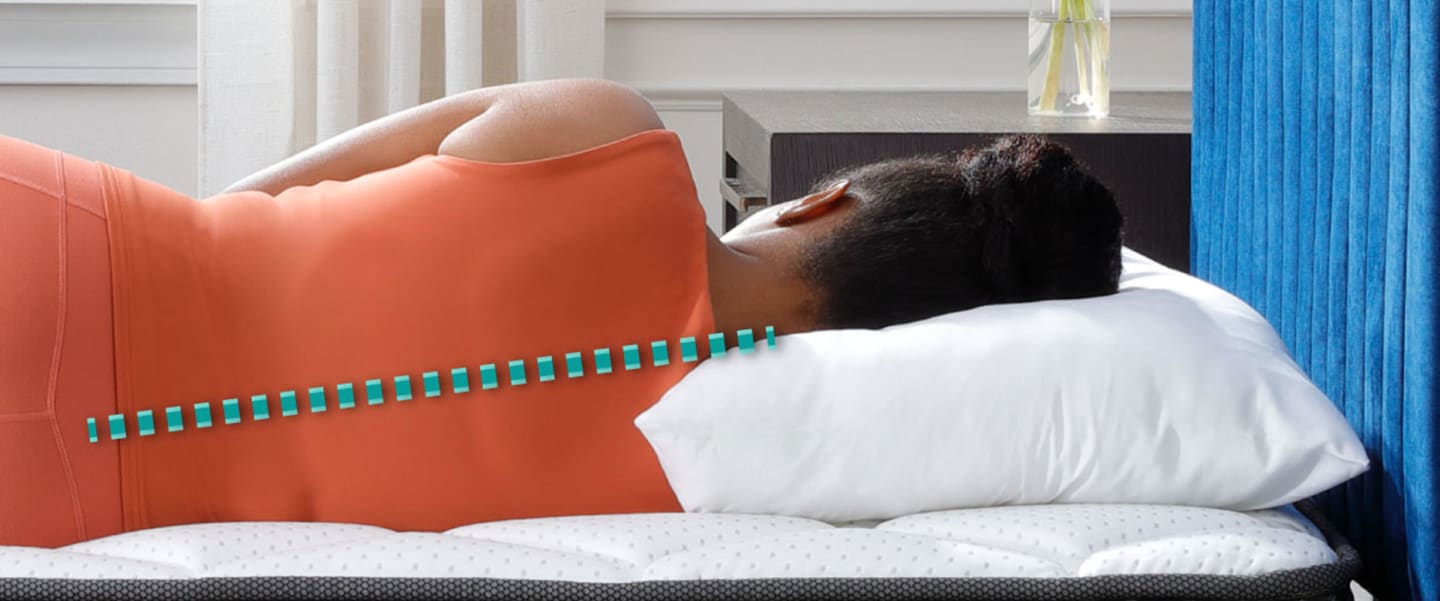 Woman laying on pillow with infographic of spine perfectly aligned